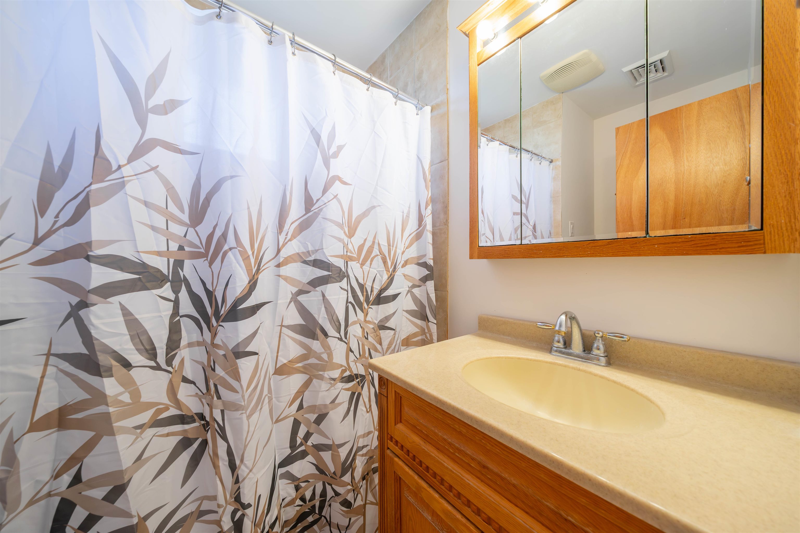 50 Vacation Villas, NJ 08251 - Photo 17 of 21 a bathroom with a sink and mirror with bathtub