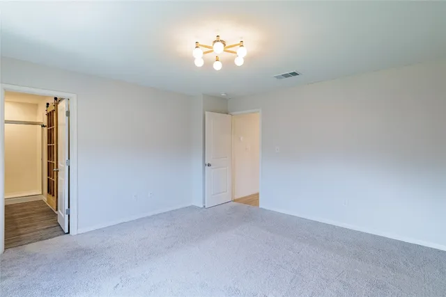 a view of a chandelier fan and entryway
