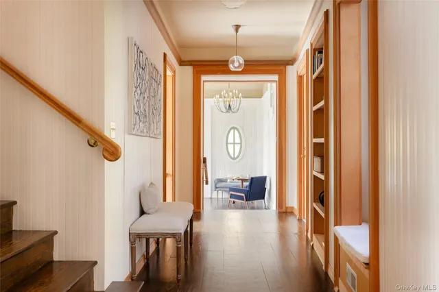 a kitchen with stainless steel appliances granite countertop white cabinets a sink and a microwave