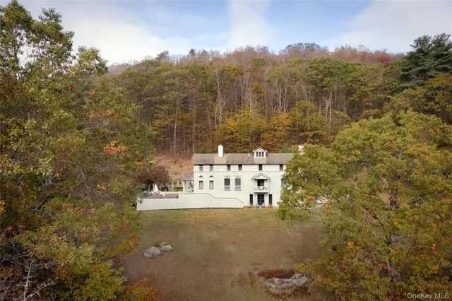 a view of staircase with large window and wooden floor
