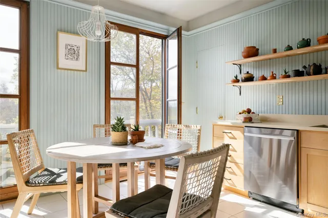 a bedroom with a bed couch and large window