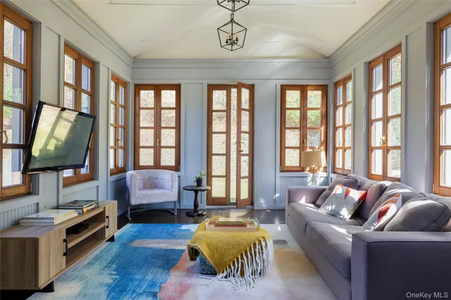 a view of a house with couches chairs and wooden floor