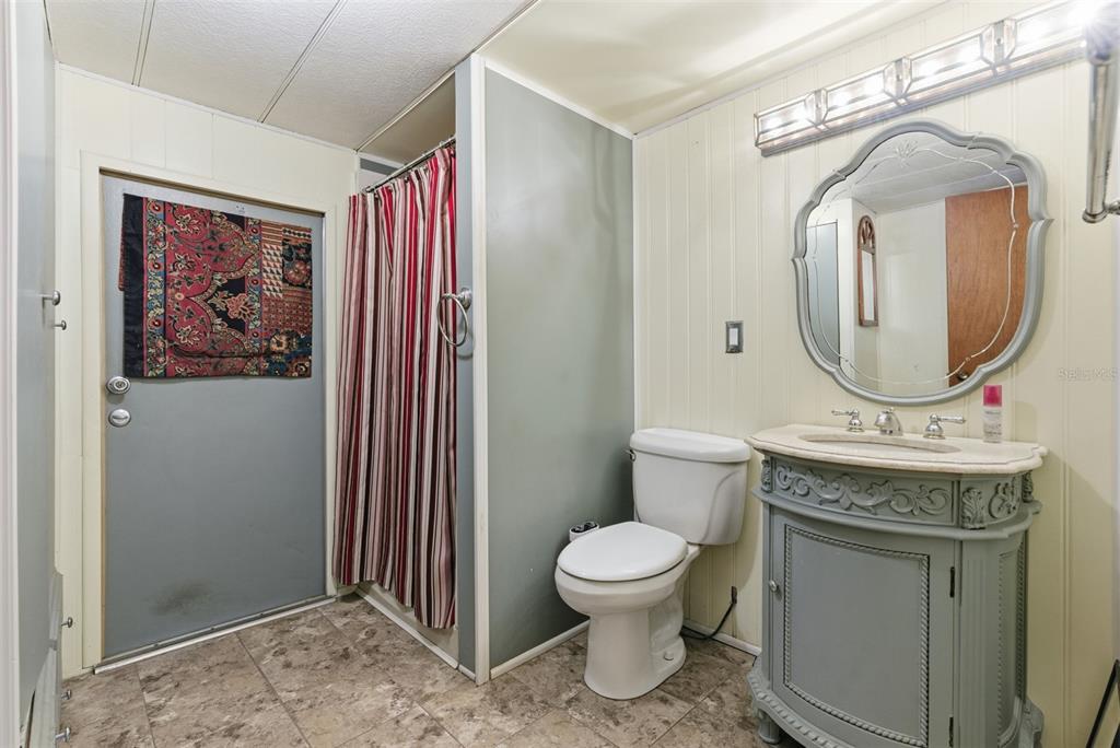6147 Ridgewood Drive Zephyrhills, FL 33542 - Photo 17 of 21 a bathroom with a toilet a sink and a mirror