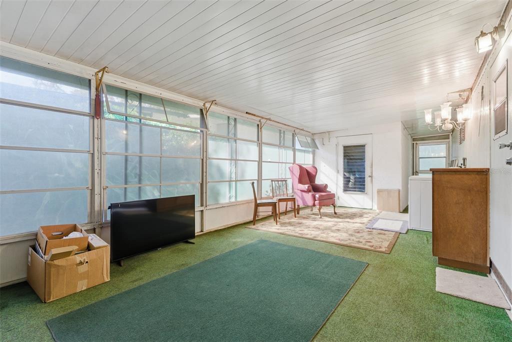 6147 Ridgewood Drive Zephyrhills, FL 33542 - Photo 18 of 21 a living room with furniture and a flat screen tv
