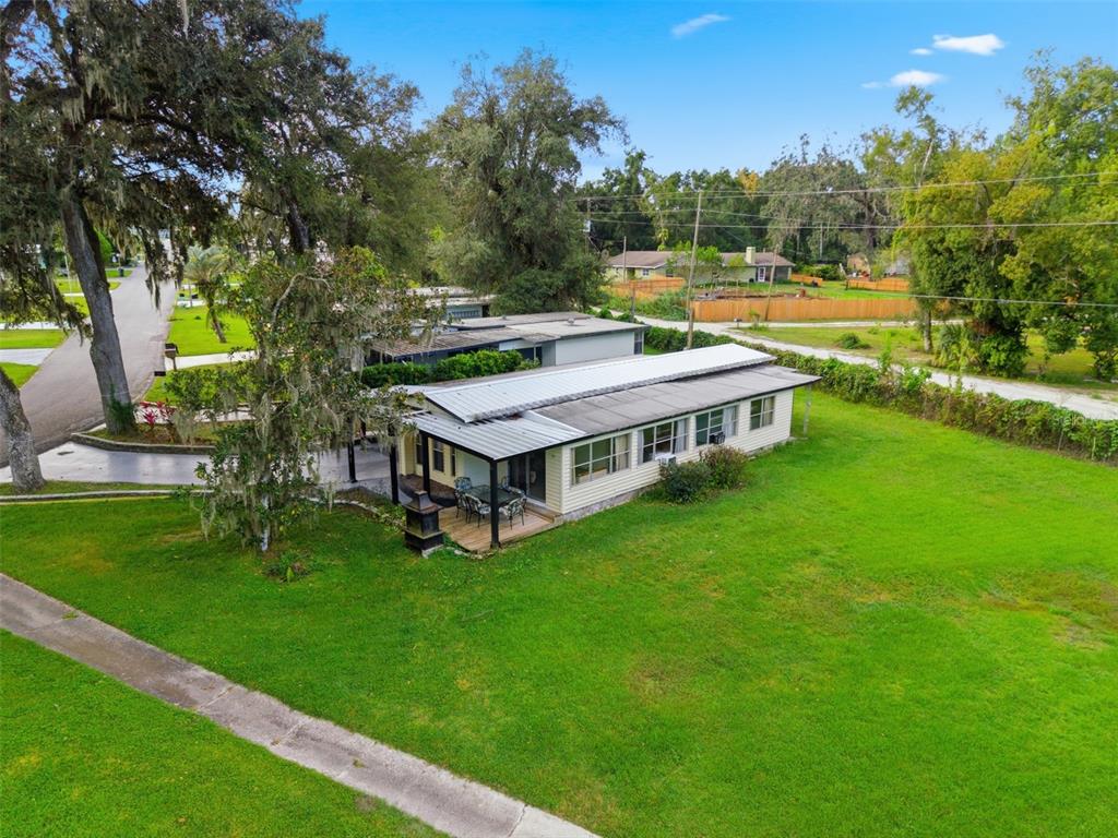 6147 Ridgewood Drive Zephyrhills, FL 33542 - Photo 2 of 21 a aerial view of a house with a big yard