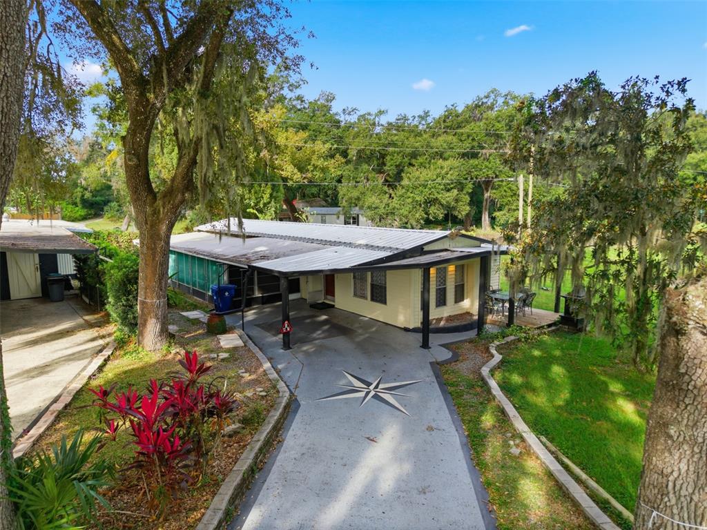 6147 Ridgewood Drive Zephyrhills, FL 33542 - Photo 3 of 21 a view of a backyard with furniture and a garden