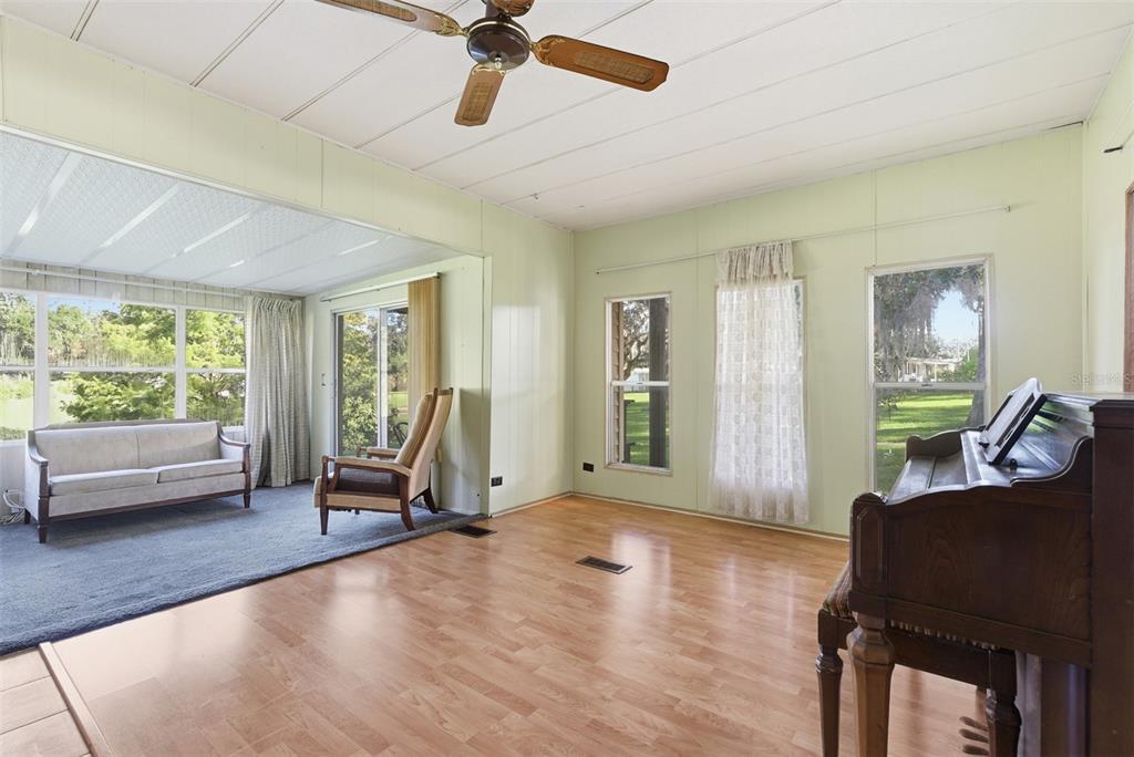 6147 Ridgewood Drive Zephyrhills, FL 33542 - Photo 8 of 21 a view of a livingroom with furniture hardwood floor and windows