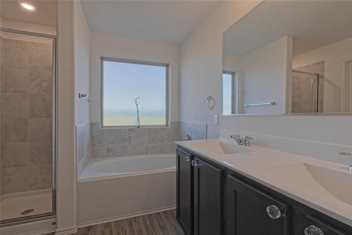 505 Greatest Gift Way Jarrell, TX 76537 - Photo 17 of 30 a bathroom with a sink a mirror and a bathtub