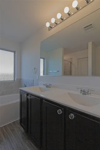 a bathroom with a double vanity sink and a mirror