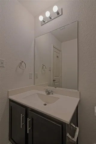 a bathroom with a sink a vanity and a mirror