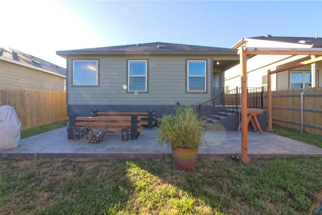 a view of a house with backyard and sitting area