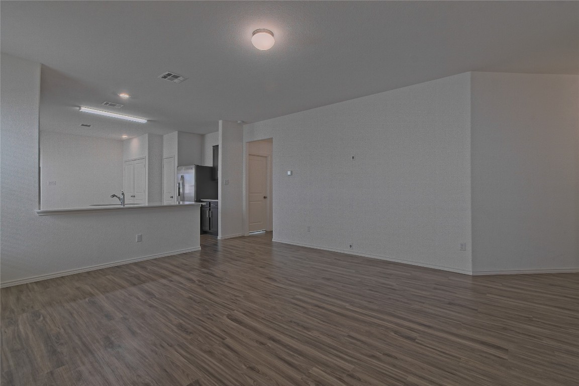 505 Greatest Gift Way Jarrell, TX 76537 - Photo 8 of 30 a view of an empty room with wooden floor