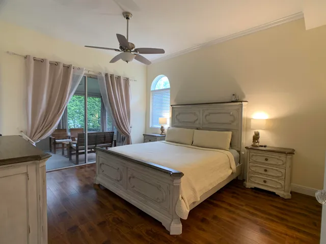 a bedroom with a bed a dresser and window