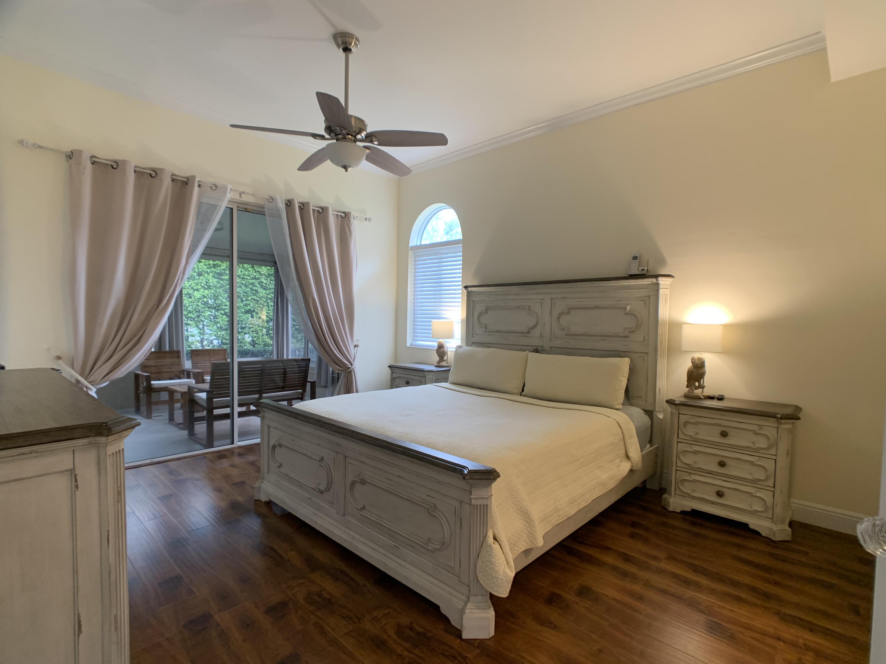 10465 Mateo Court Boca Raton, FL 33498 - Photo 14 of 36 a bedroom with a bed a dresser and window