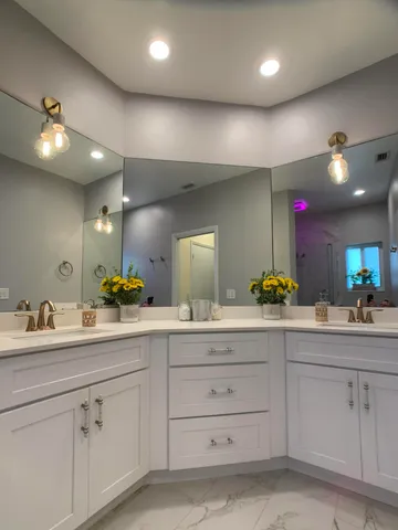 a bathroom with a sink vanity and mirror