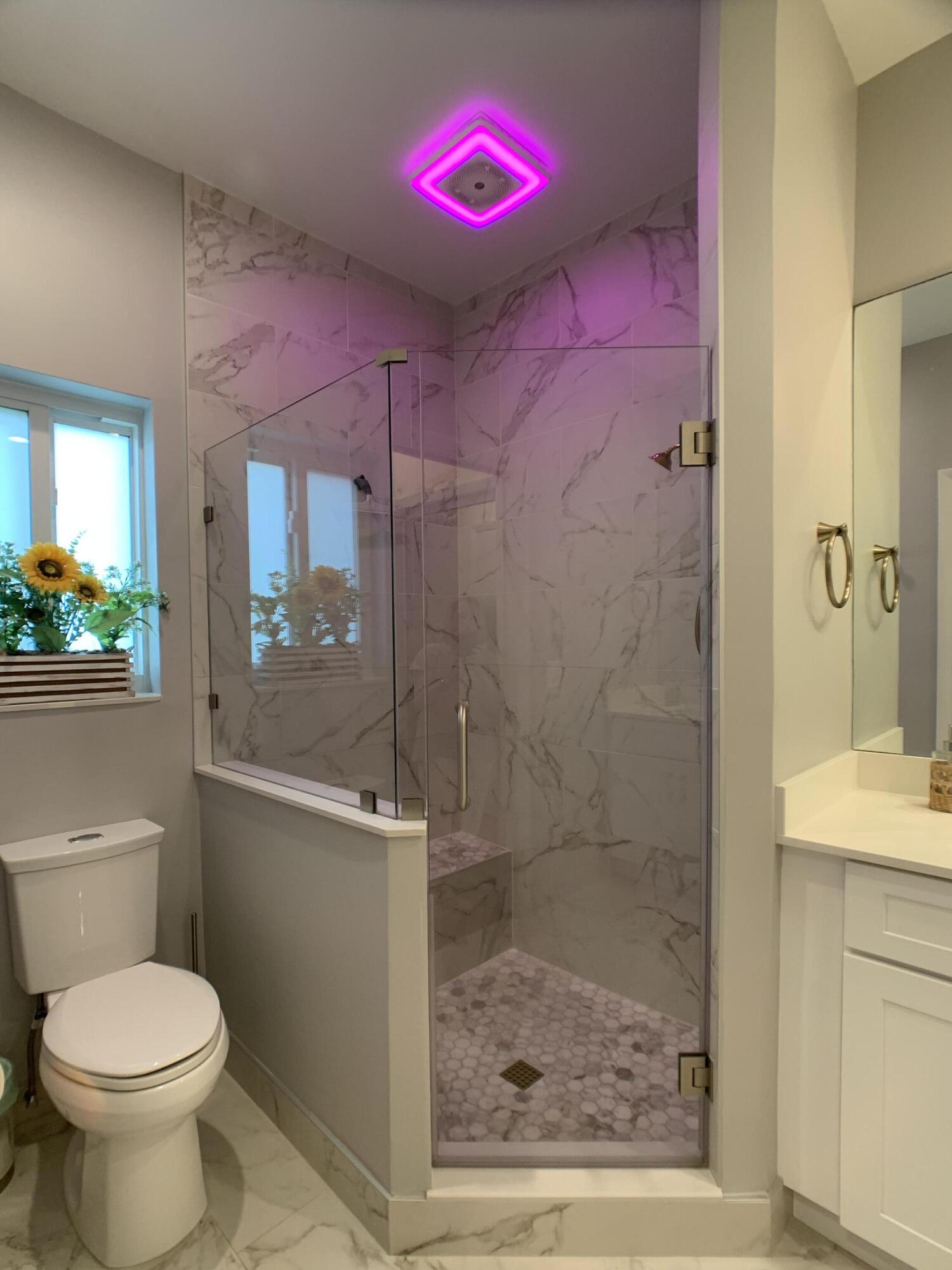 10465 Mateo Court Boca Raton, FL 33498 - Photo 16 of 36 a bathroom with a shower sink mirror and toilet