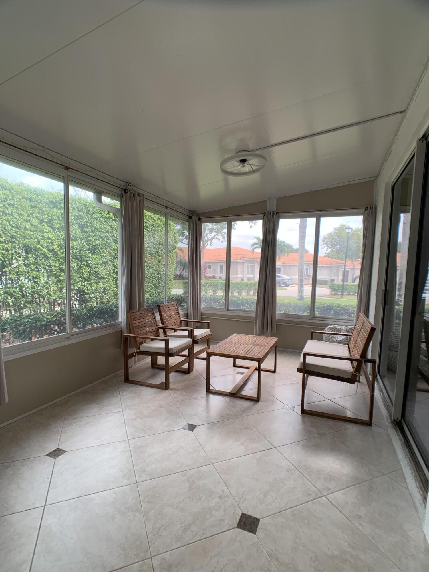 10465 Mateo Court Boca Raton, FL 33498 - Photo 28 of 36 a living room with furniture and a large window