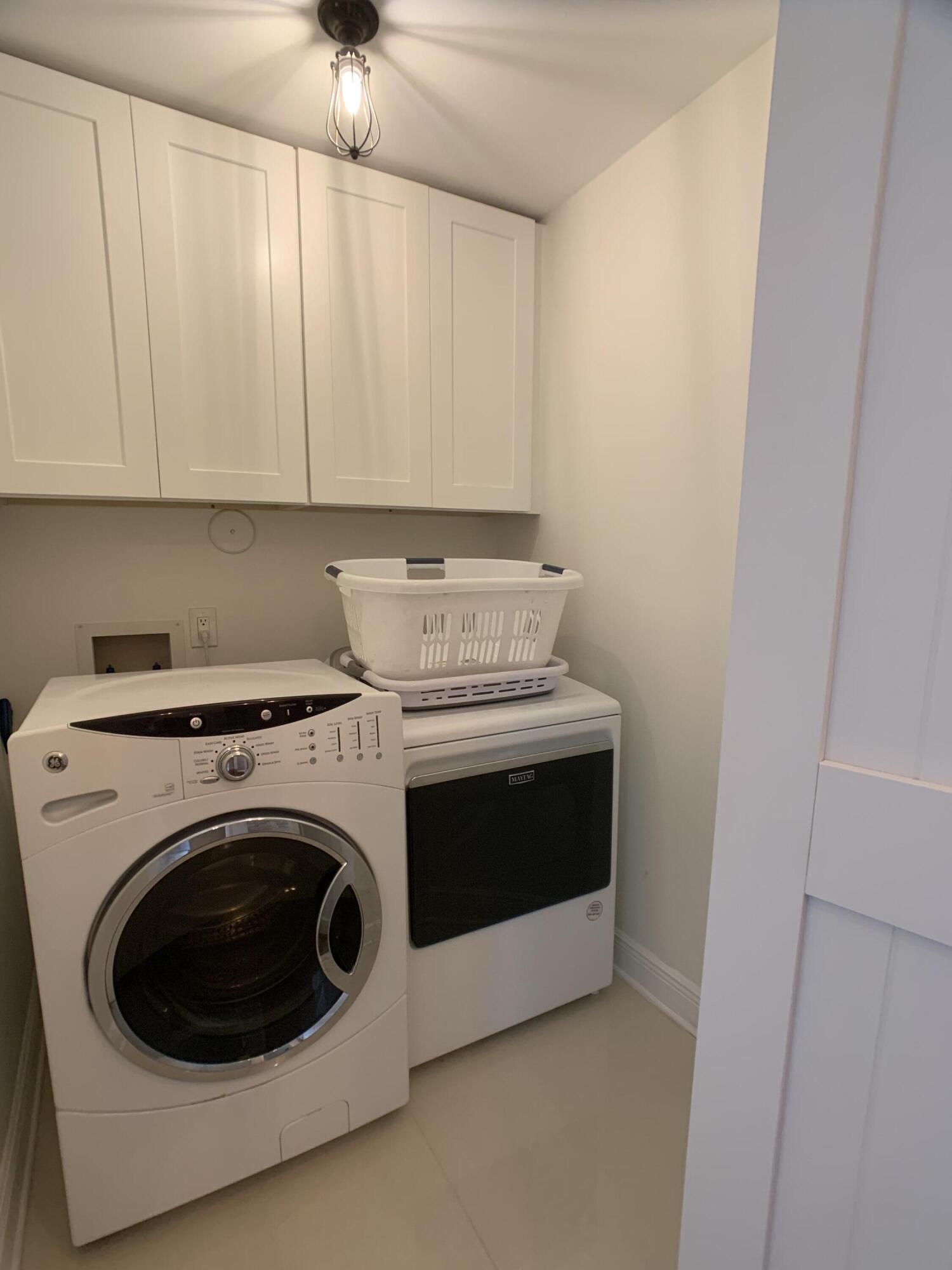 10465 Mateo Court Boca Raton, FL 33498 - Photo 32 of 36 a utility room with dryer and washer