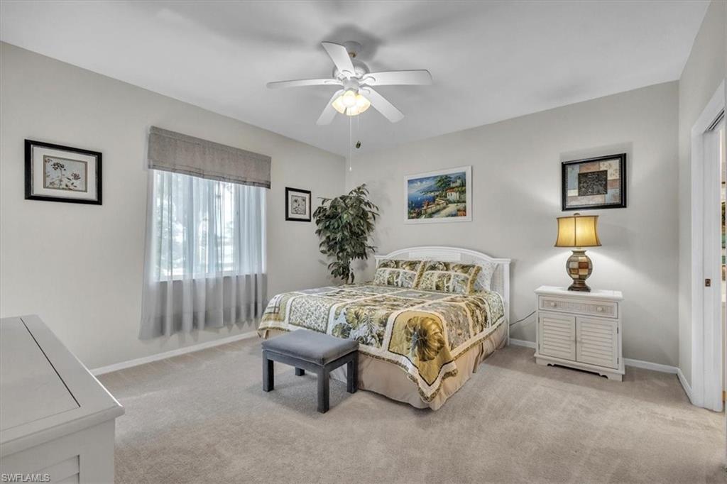 8075 Tiger Cove, Unit 1706 Naples, FL 34113 - Photo 15 of 50 Bedroom with light colored carpet and a ceiling fan