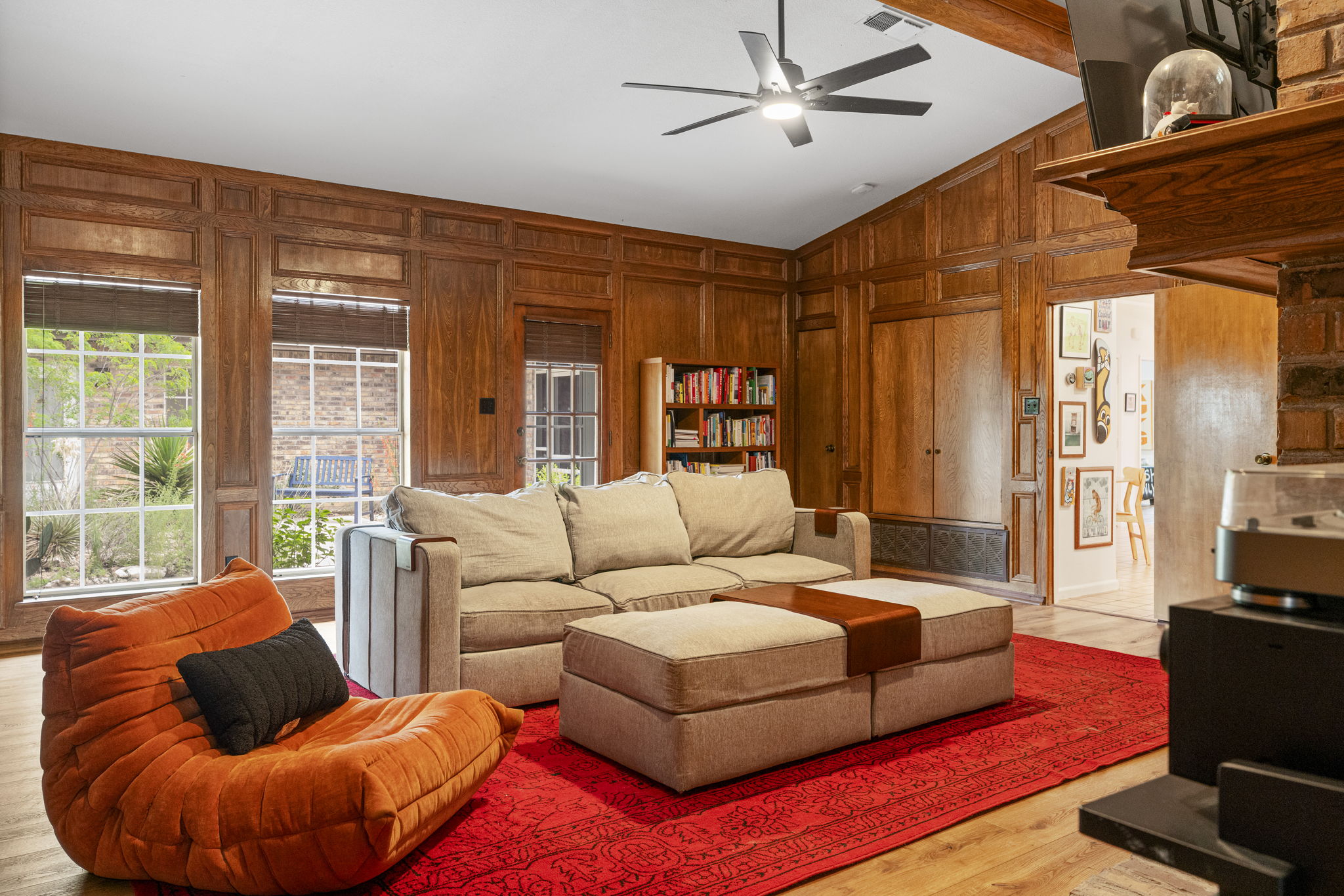 400 Hackberry Street Lockhart, TX 78644 - Photo 6 of 40 Rich wood paneling surrounds this inviting living space, bathed in natural light from the large windows.