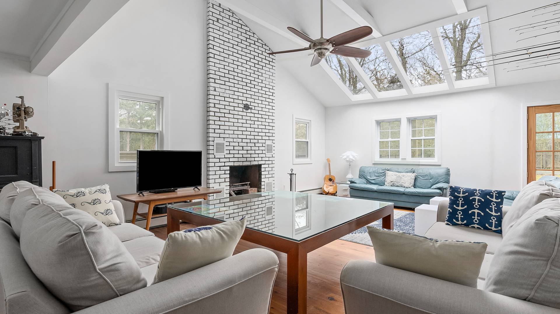 28 Pine Tree Road Southampton, NY 11968 - Photo 3 of 14 a living room with furniture a flat screen tv and a window