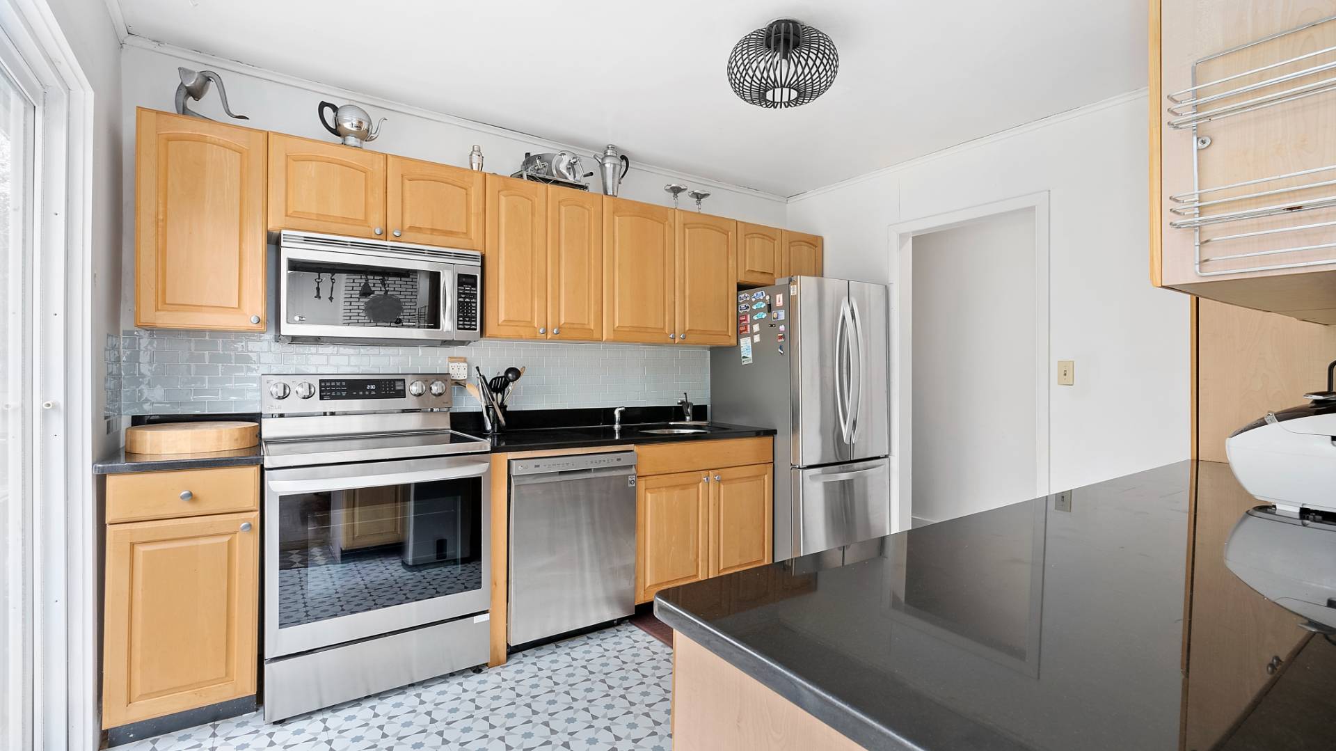 28 Pine Tree Road Southampton, NY 11968 - Photo 5 of 14 a kitchen with stainless steel appliances granite countertop a stove a microwave and a refrigerator