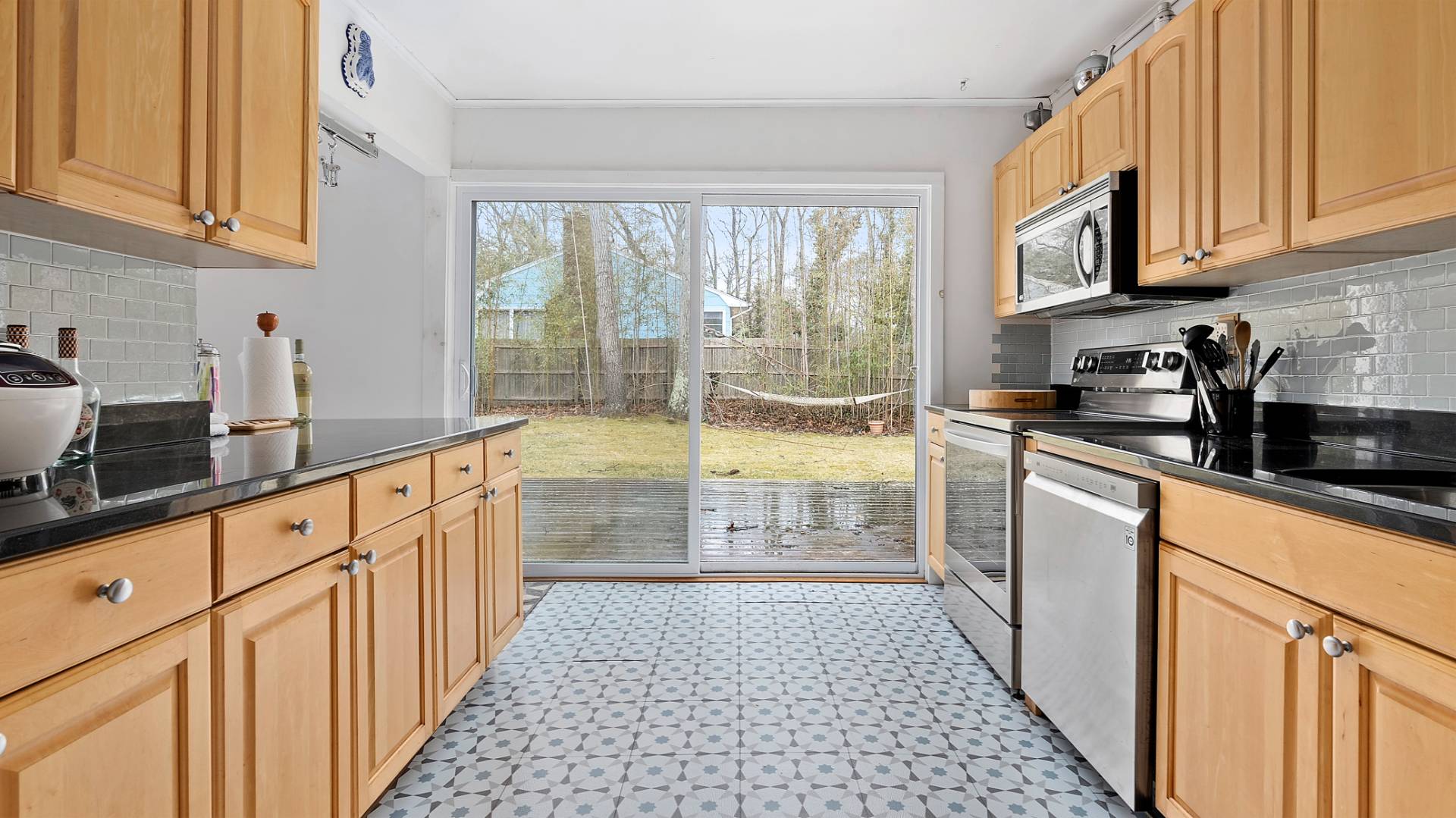 28 Pine Tree Road Southampton, NY 11968 - Photo 6 of 14 a kitchen with stainless steel appliances a stove a sink and a white cabinets