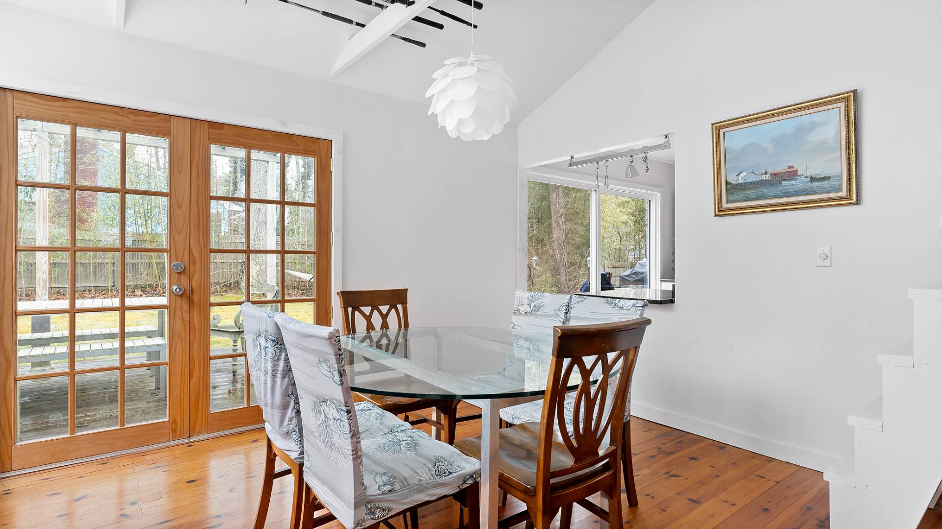 28 Pine Tree Road Southampton, NY 11968 - Photo 7 of 14 a view of a dining room with furniture a chandelier and wooden floor
