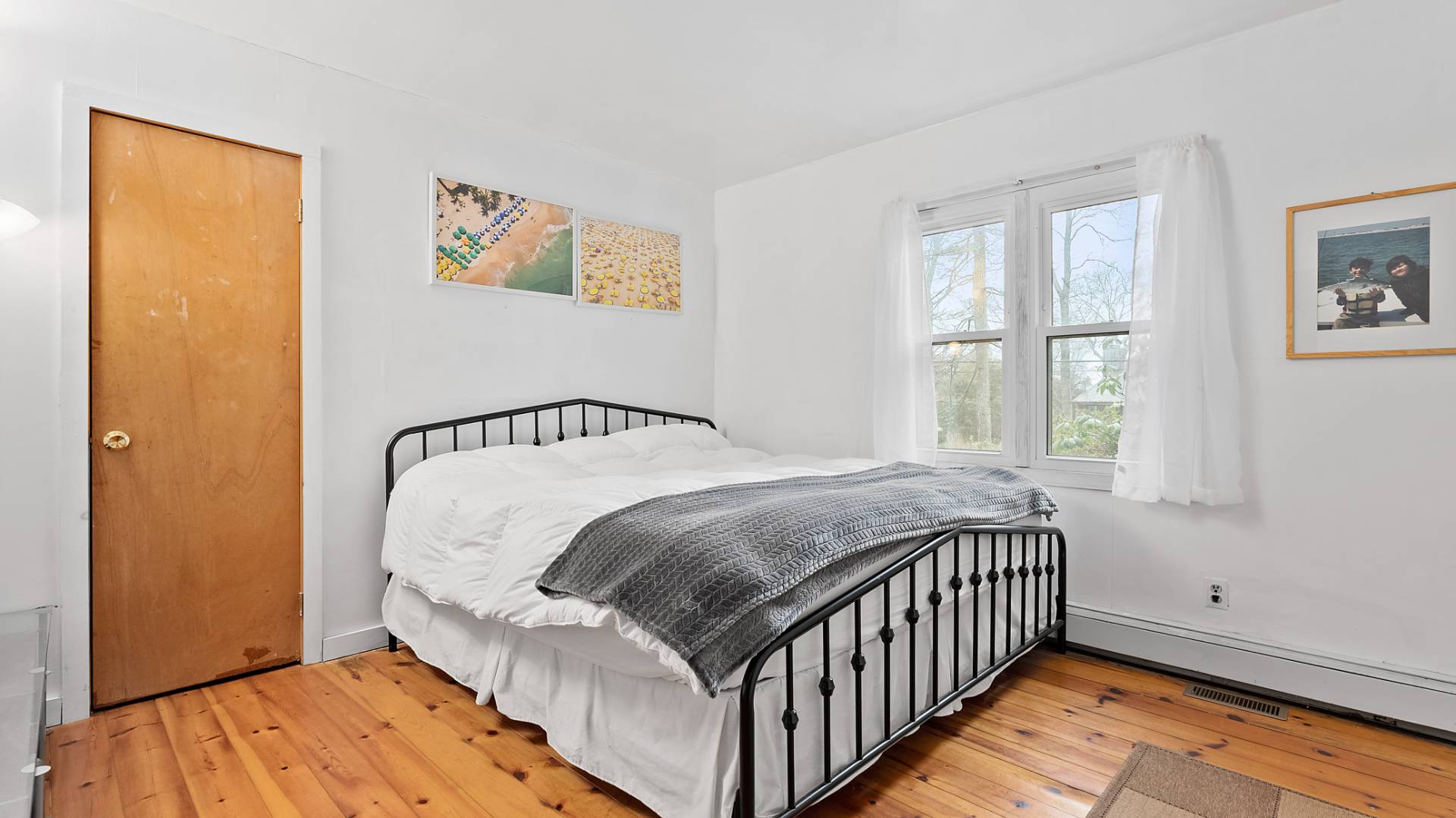 28 Pine Tree Road Southampton, NY 11968 - Photo 8 of 14 a bed sitting in a bedroom next to a window