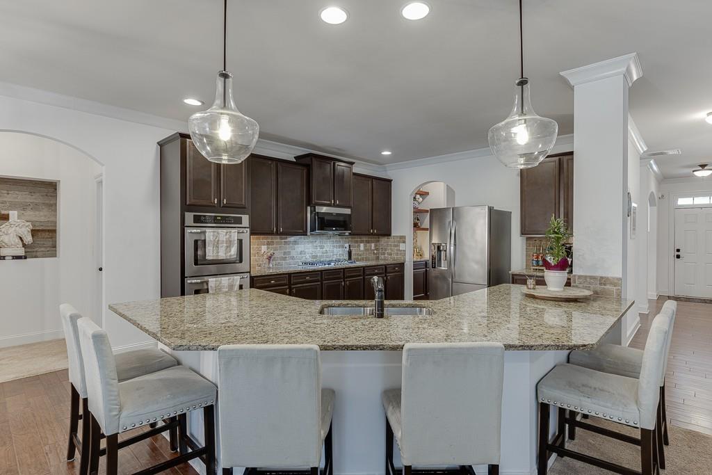 2906 Jones Phillips Road Dacula, GA 30019 - Photo 15 of 53 a kitchen with stainless steel appliances granite countertop a dining table chairs and refrigerator