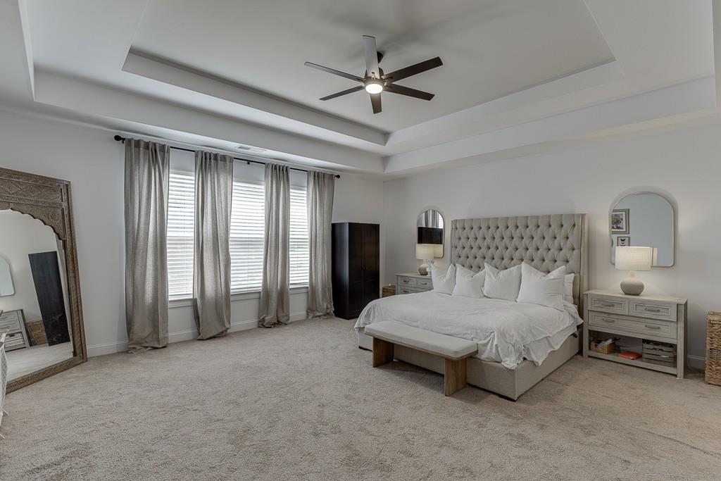 2906 Jones Phillips Road Dacula, GA 30019 - Photo 23 of 53 a spacious bedroom with a bed a ceiling fan and a large window