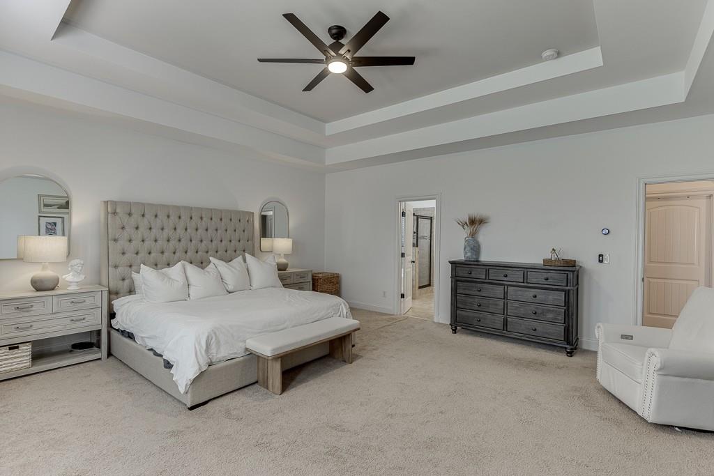 2906 Jones Phillips Road Dacula, GA 30019 - Photo 24 of 53 a bedroom with a bed and a chandelier