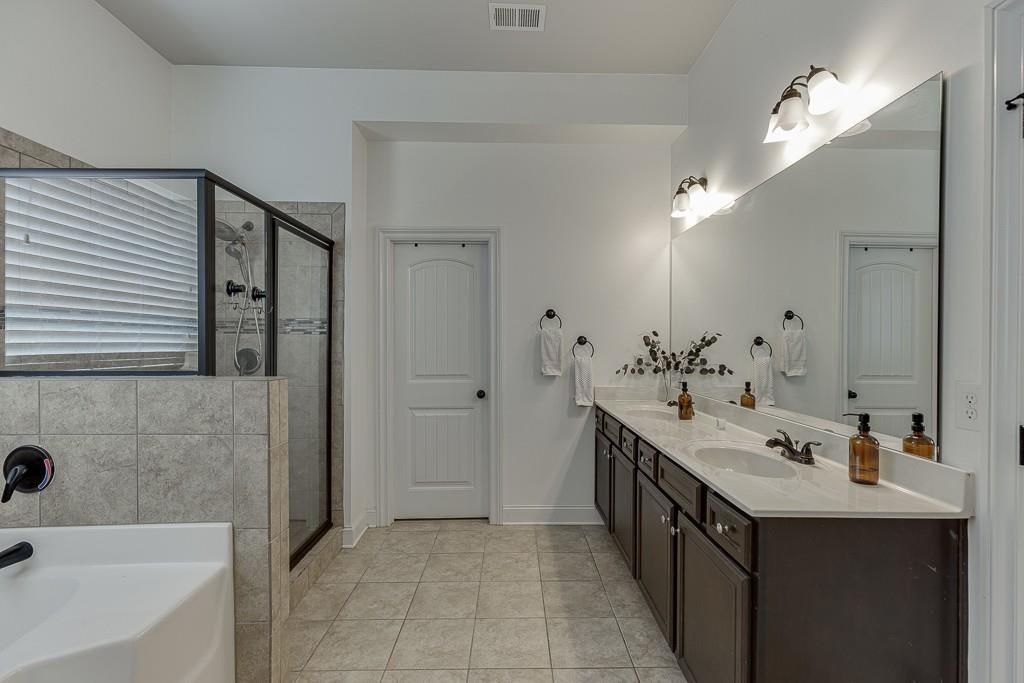 2906 Jones Phillips Road Dacula, GA 30019 - Photo 26 of 53 a bathroom with a tub sink and mirror