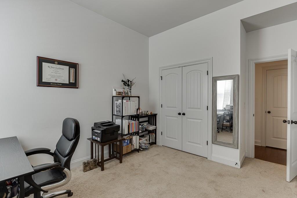 2906 Jones Phillips Road Dacula, GA 30019 - Photo 30 of 53 a view of a workspace with furniture and closet