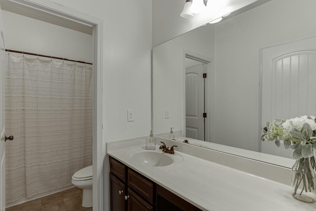 2906 Jones Phillips Road Dacula, GA 30019 - Photo 31 of 53 a bathroom with a sink a toilet and shower