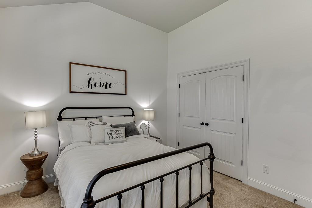 2906 Jones Phillips Road Dacula, GA 30019 - Photo 33 of 53 a bedroom with a bed and a night stand