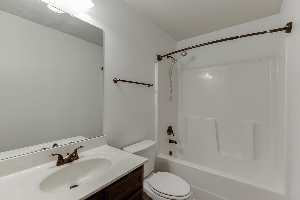 2906 Jones Phillips Road Dacula, GA 30019 - Photo 34 of 53 a bathroom with a sink toilet and shower