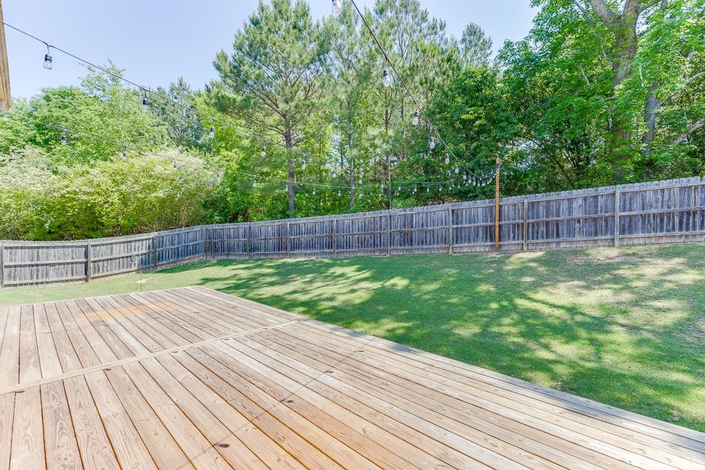 2906 Jones Phillips Road Dacula, GA 30019 - Photo 42 of 53 a view of a backyard with a wooden fence