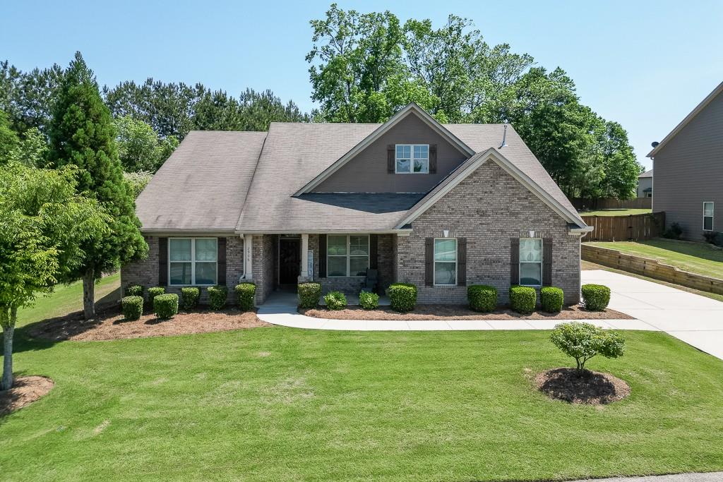 2906 Jones Phillips Road Dacula, GA 30019 - Photo 53 of 53 a front view of a house with a yard table and chairs