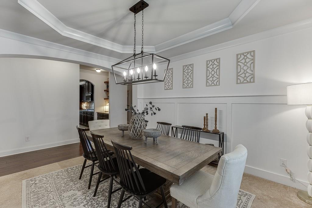 2906 Jones Phillips Road Dacula, GA 30019 - Photo 6 of 53 a view of a dining room with furniture and chandelier