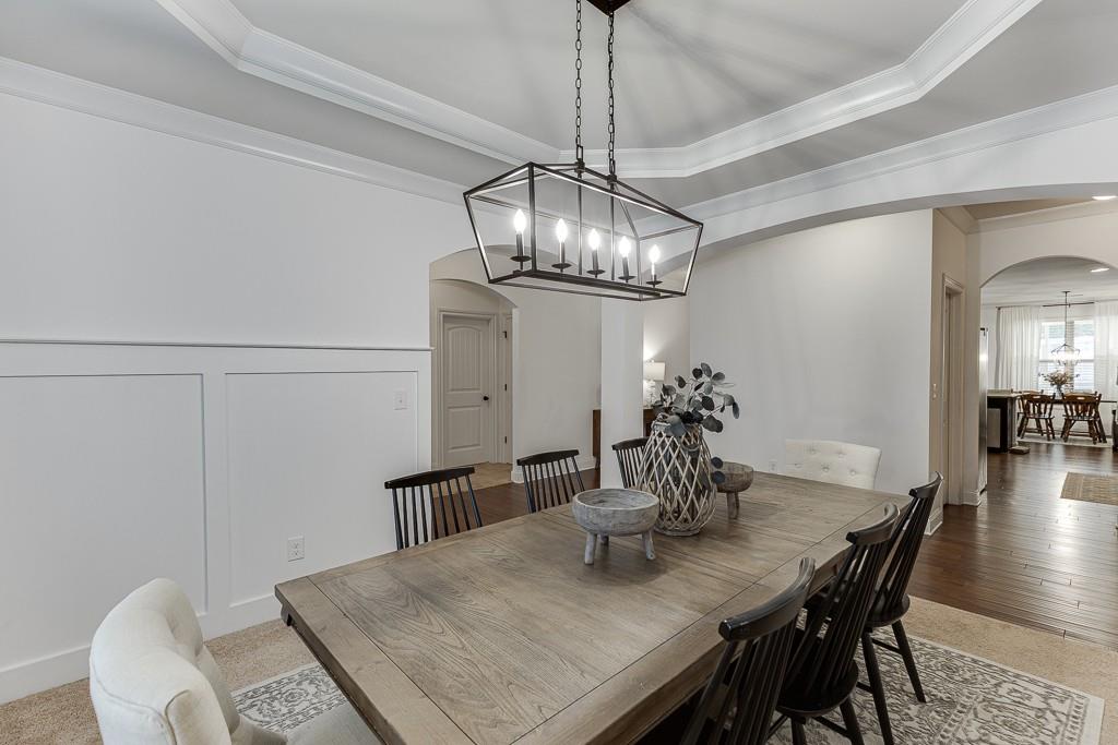 2906 Jones Phillips Road Dacula, GA 30019 - Photo 7 of 53 a view of a dining room with furniture and wooden floor