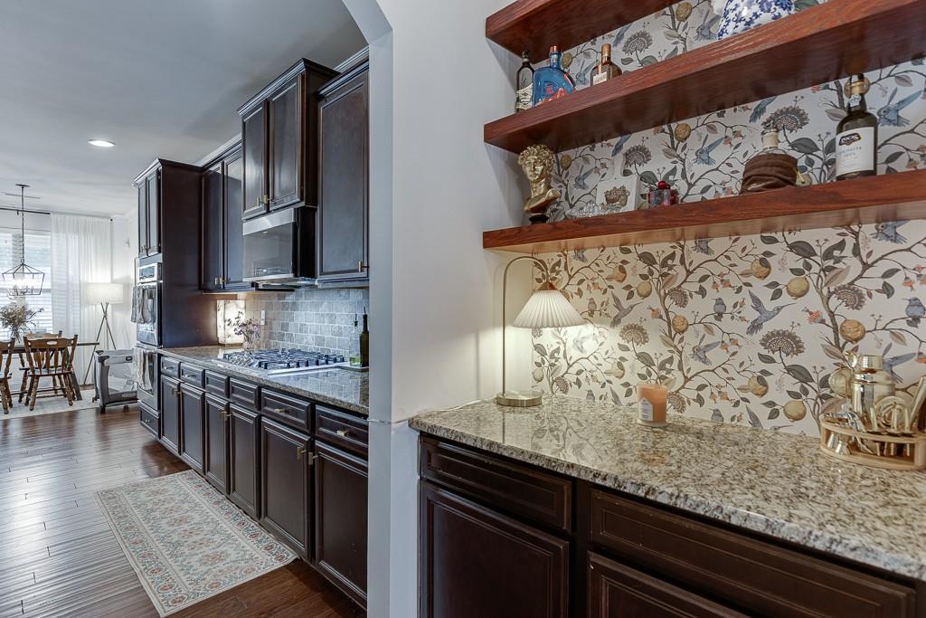 2906 Jones Phillips Road Dacula, GA 30019 - Photo 8 of 53 a kitchen with stainless steel appliances granite countertop a stove a sink and a microwave