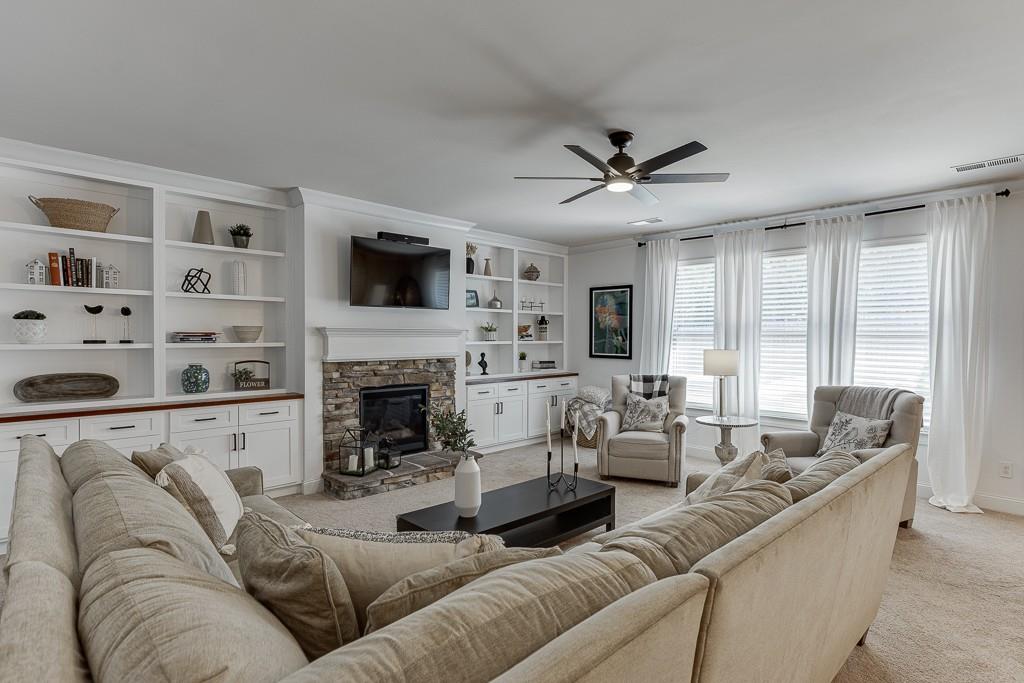 2906 Jones Phillips Road Dacula, GA 30019 - Photo 9 of 53 a living room with furniture fireplace and flat screen tv