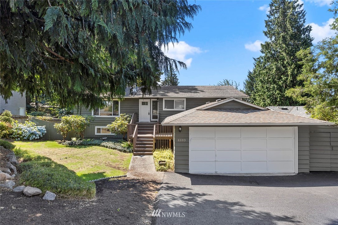6609 Southeast 4th Place Renton, WA 98059 - Photo 1 of 26 a front view of a house with a yard
