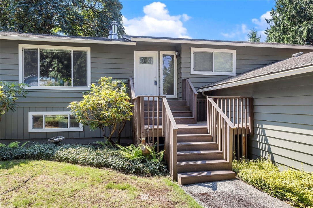 6609 Southeast 4th Place Renton, WA 98059 - Photo 2 of 26 a front view of a house with a garden