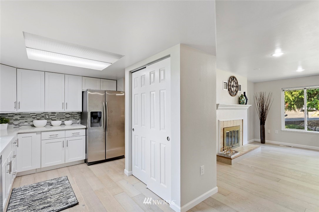 6609 Southeast 4th Place Renton, WA 98059 - Photo 11 of 26 a kitchen with stainless steel appliances granite countertop a refrigerator and a stove top oven