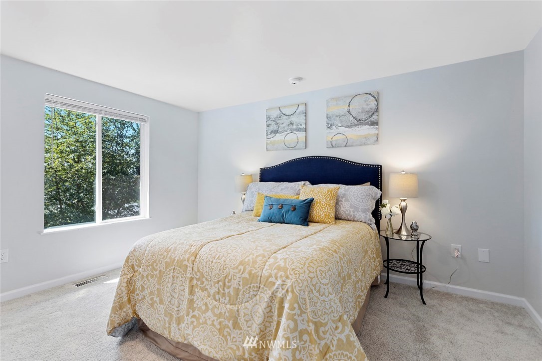 6609 Southeast 4th Place Renton, WA 98059 - Photo 13 of 26 a bedroom with a bed and a large window