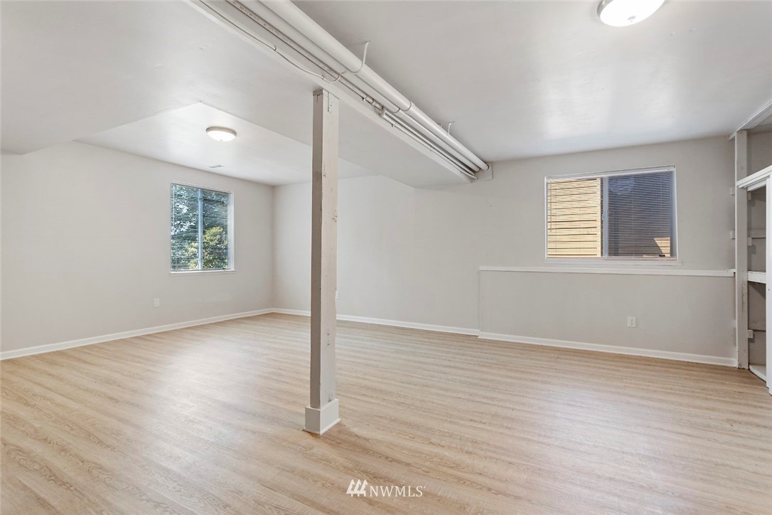 6609 Southeast 4th Place Renton, WA 98059 - Photo 14 of 26 an empty room with wooden floor and windows