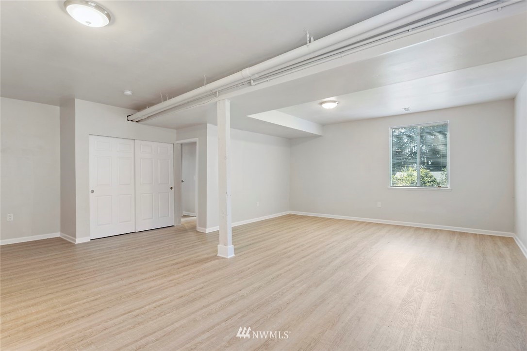 6609 Southeast 4th Place Renton, WA 98059 - Photo 15 of 26 an empty room with wooden floor and windows