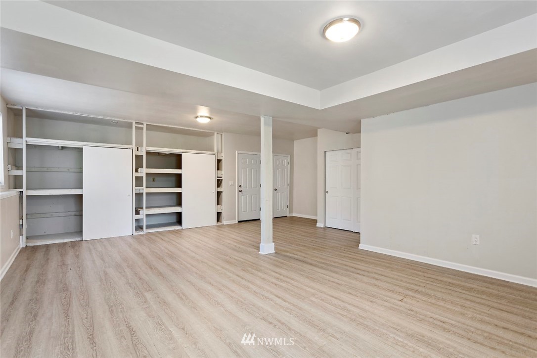 6609 Southeast 4th Place Renton, WA 98059 - Photo 16 of 26 a view of empty room with wooden floor and closet